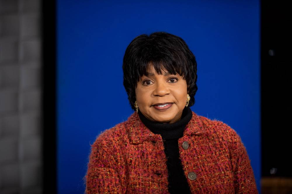 Cheryl Brown Henderson with background of blue screen behind her